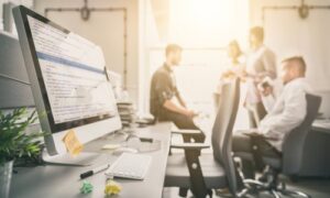 people talking in office with computer - boutique developer development - waypath