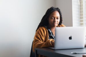 woman sitting at table working on laptop | WayPath